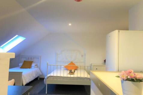 A bright and clean double bedroom featuring two...