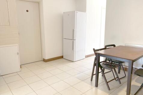 A bright and clean kitchen space featuring a wh...