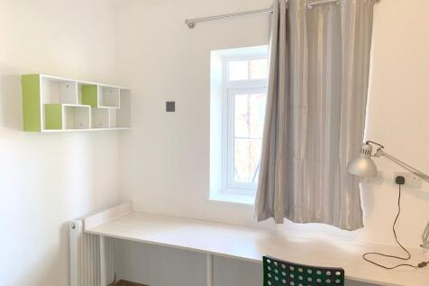 A bright and tidy communal workspace featuring ...