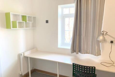 A bright and tidy communal workspace featuring ...