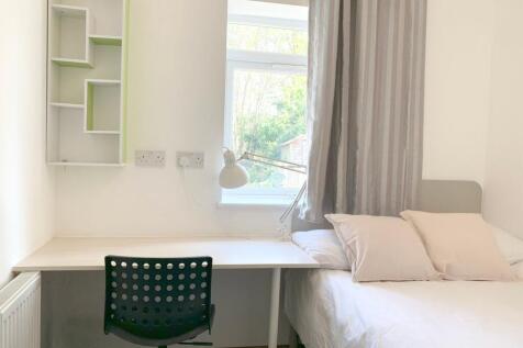 A bright and tidy single bedroom featuring a co...