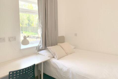 Bright and tidy single bedroom featuring a neat...
