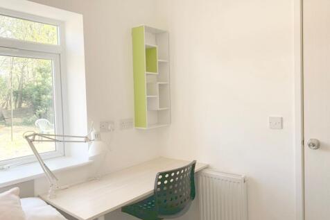 Bright and tidy single bedroom corner featuring...
