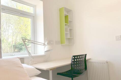 Bright and tidy single bedroom featuring a cozy...