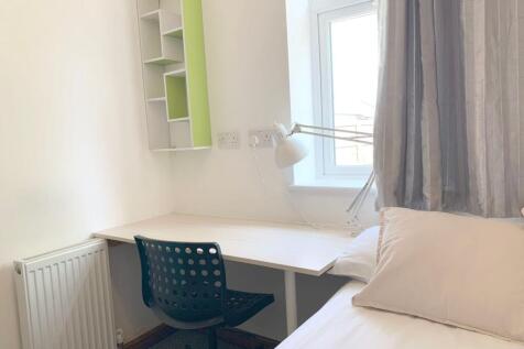 Bright and tidy single bedroom corner with a wh...