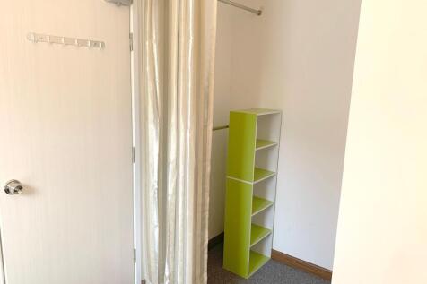 A neat and tidy small storage area featuring a ...