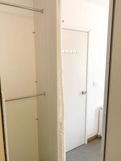 A small and clean storage area with a hanging r...