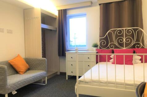 Bright and welcoming double bedroom featuring a...