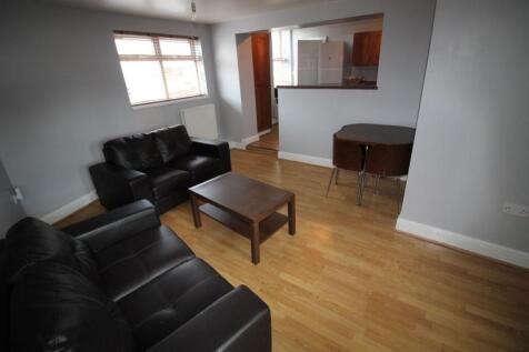 A modern living room featuring comfortable blac...