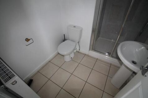 A neat and functional bathroom featuring a whit...