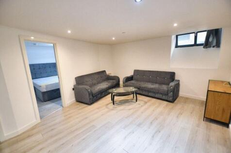 Contemporary living room featuring two stylish ...
