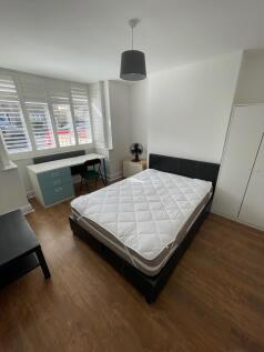 A neat and bright double bedroom featuring a co...