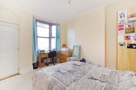 A bright and cozy single bedroom featuring a ba...