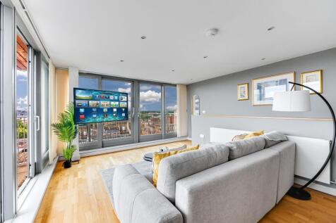 A modern living room with expansive floor-to-ce...