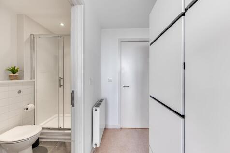 A clean and modern single toilet area featuring...