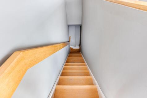 A clean and well-maintained wooden staircase wi...