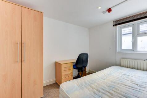 A tidy double bedroom featuring a double bed, a...