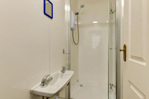 A clean and modern bathroom featuring a glass s...