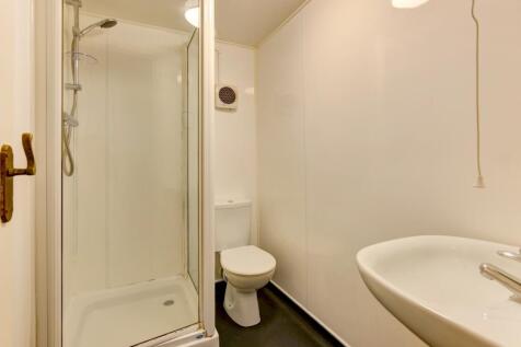 A clean, modern bathroom featuring a spacious s...