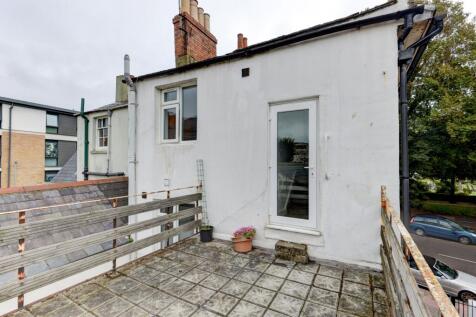 Charming exterior view of a terraced house feat...