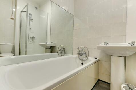 Bright and modern bathroom suite featuring a cl...