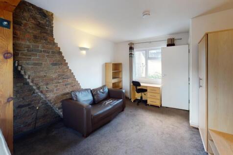 A cozy living room featuring a comfortable leat...