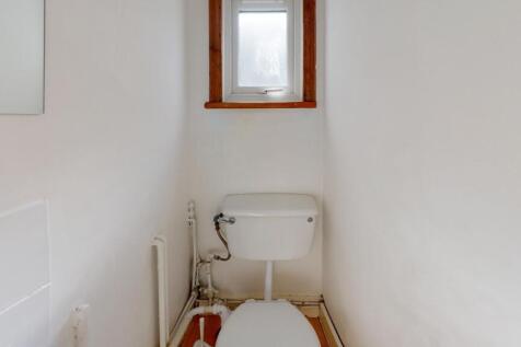 Compact and clean single toilet room with a sim...