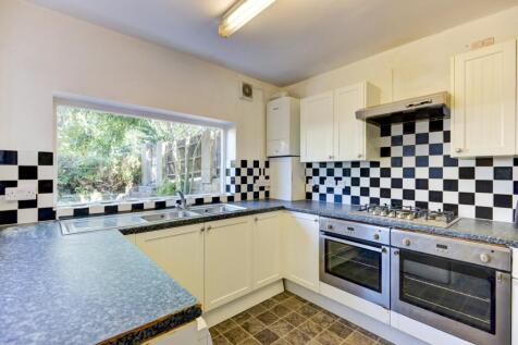 Bright kitchen featuring a large window that fi...