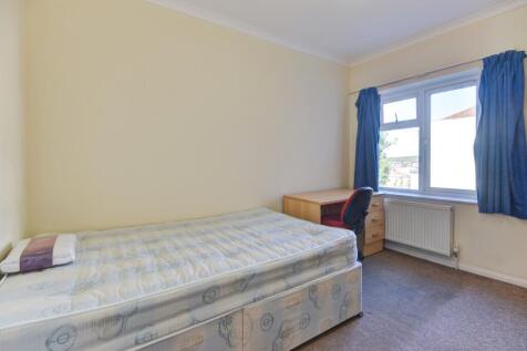 A clean and simple bedroom featuring a single b...