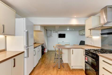 Bright and modern kitchen featuring ample count...