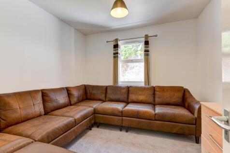 A cozy living room featuring a large L-shaped b...