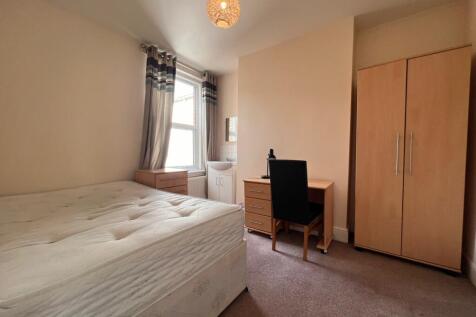 A bright and inviting double bedroom featuring ...