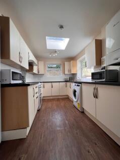 Bright and modern kitchen featuring ample count...