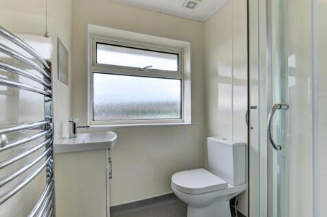 Bright and clean bathroom featuring a modern sh...