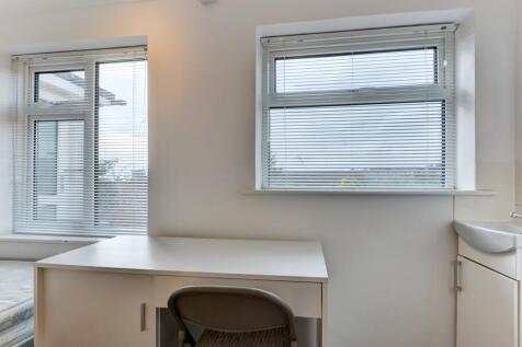 A bright and airy communal workspace featuring ...