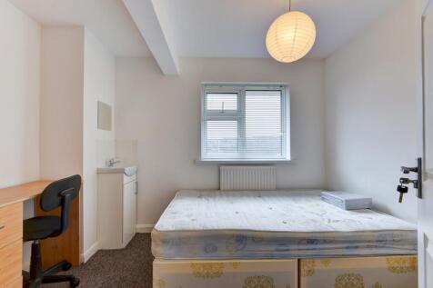 Bright and clean student bedroom featuring a ne...
