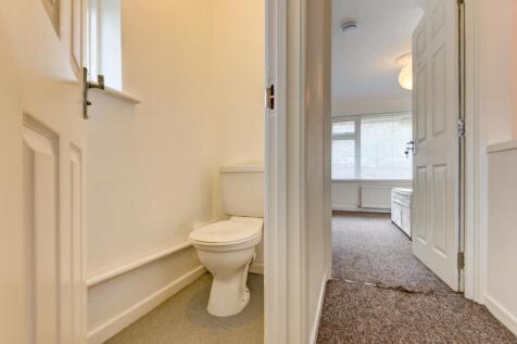Bright and tidy single toilet with a clear whit...