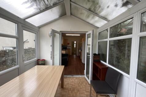 Bright and airy communal lounge area with large...