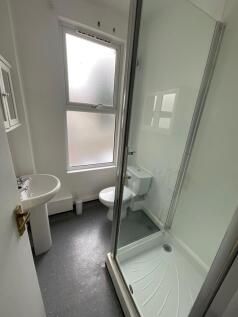 Bright and clean bathroom featuring a modern sh...