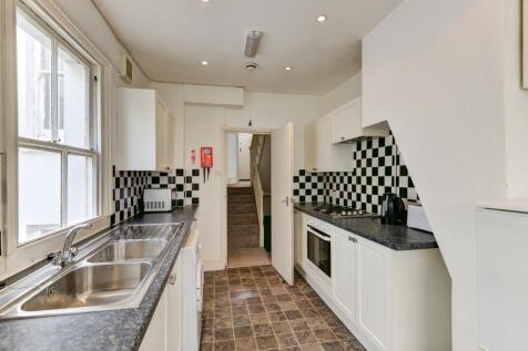 Bright and tidy kitchen featuring modern checke...