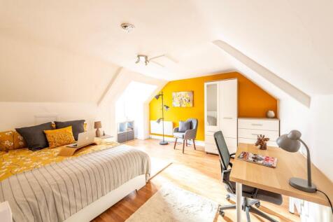 A bright and spacious master bedroom featuring ...
