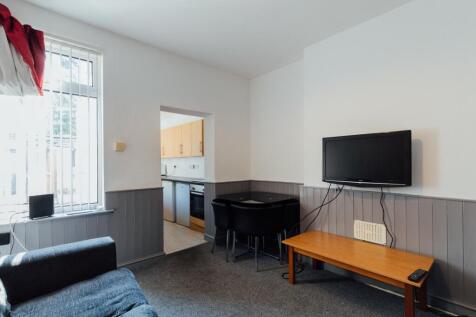A well-lit, inviting living room featuring a co...