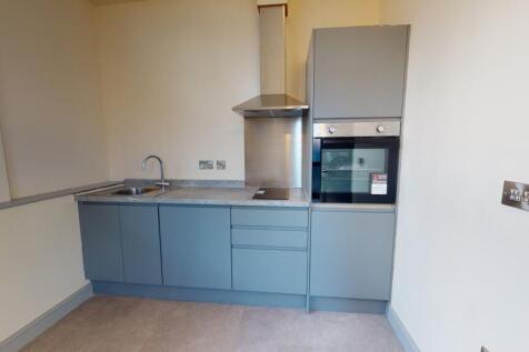 Modern, clean kitchen with blue cabinetry, a st...