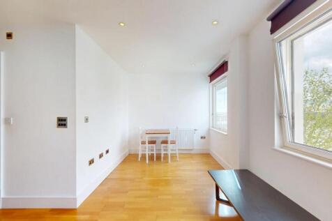 A bright and airy living room with large window...