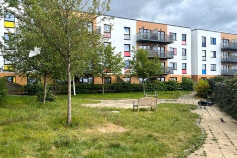 A well-maintained garden area with green grass,...