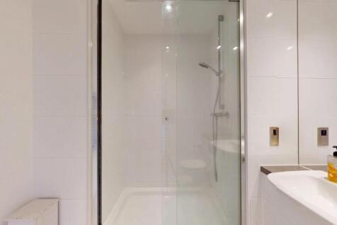 A modern and spotless bathroom featuring a larg...
