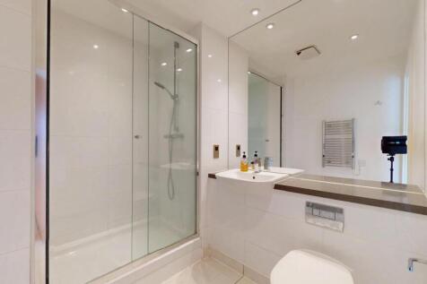 Bright and modern bathroom suite featuring a sp...