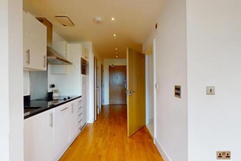 A clean and bright hallway with polished wooden...