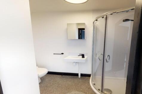 Modern student bathroom with a shower cubicle, ...