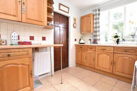 A bright and tidy kitchen with natural light st...
